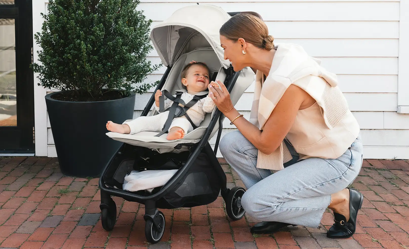 Parent with smiling child in Minu stroller